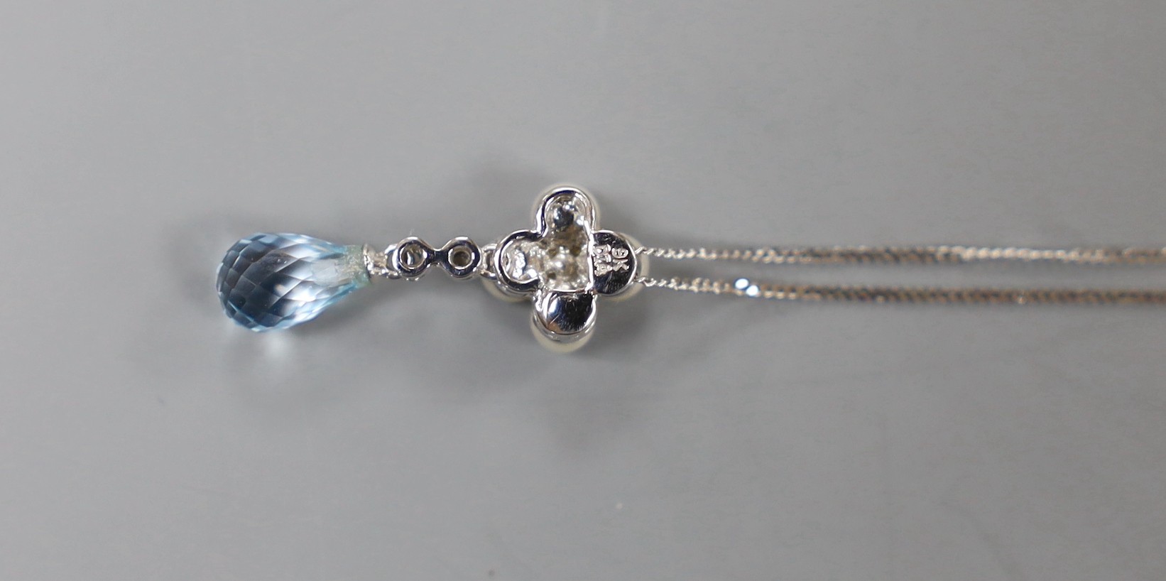 A modern 9k white metal, blue topaz, cultured pearl and diamond cluster set drop pendant, 23mm, on a 375 fine link chain, 46cm, gross weight 2.2 grams.